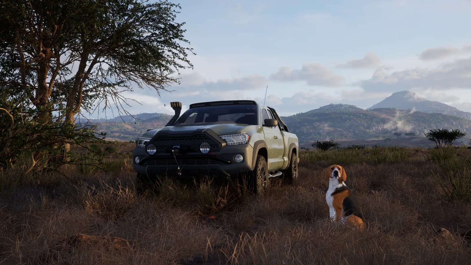 A hound sits beside a field vehicle on a dirt track.